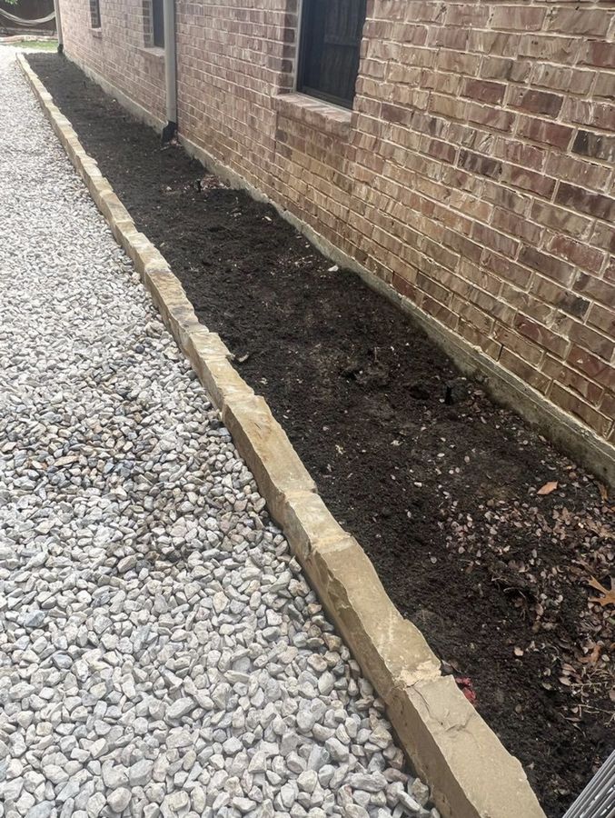 Cut-stone border holding a gravel bed against the house