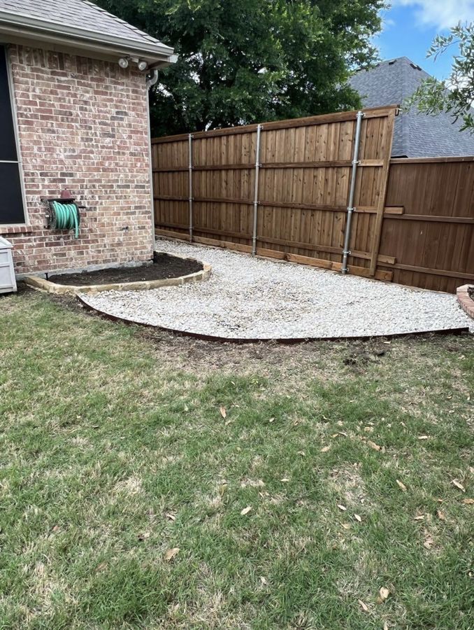A side yard that stayed wet, fixed with gravel and stone in Allen — Gravel pad at the corner of the house