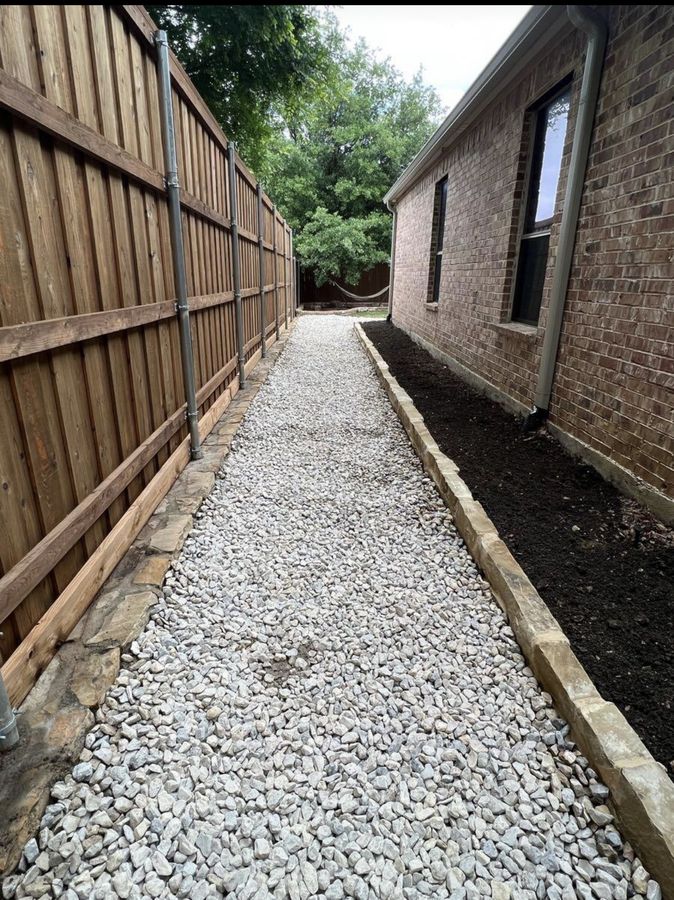 A side yard that stayed wet, fixed with gravel and stone in Allen — Gravel run along the fence line