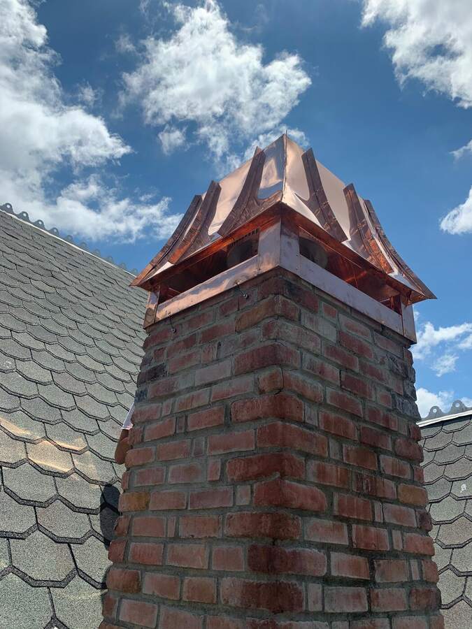 Brick chimney finished with a custom copper cap