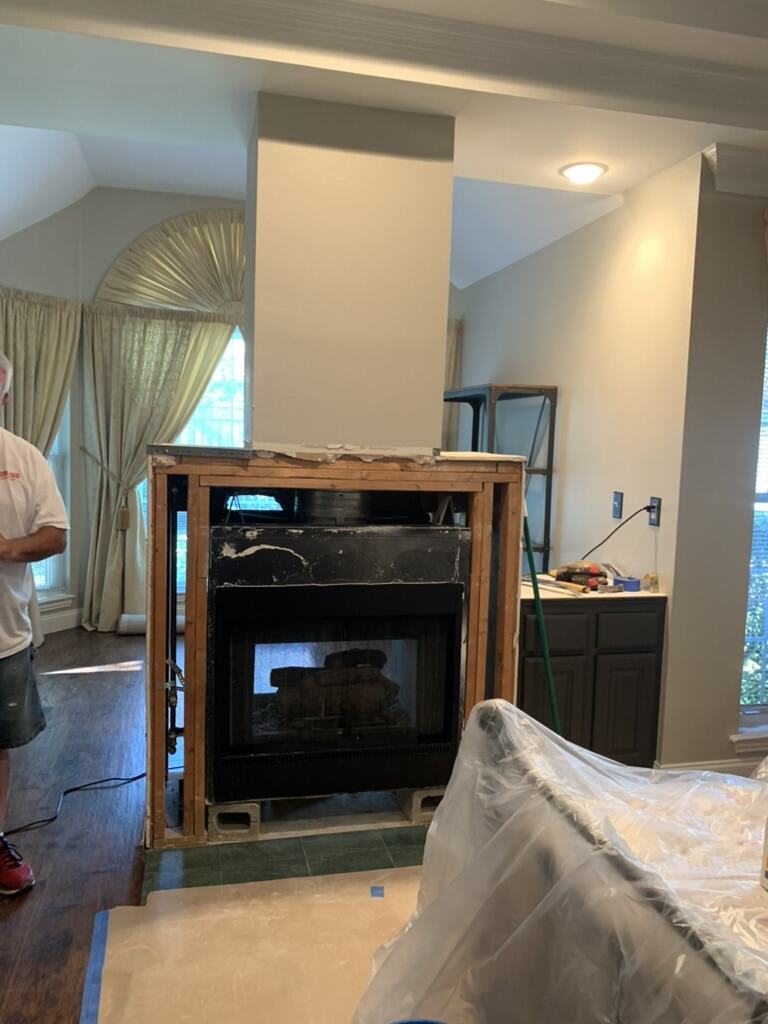 Before: old fireplace insert framed out with bare studs