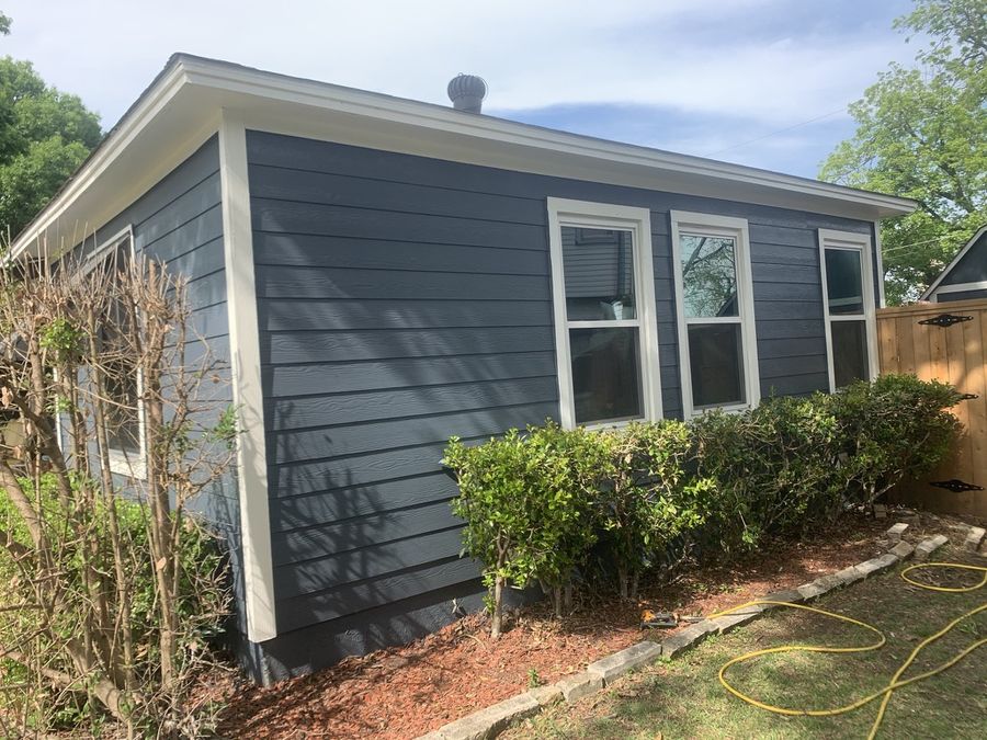 Whole-house re-side, cream to navy in Downtown Garland — After — new siding and trim