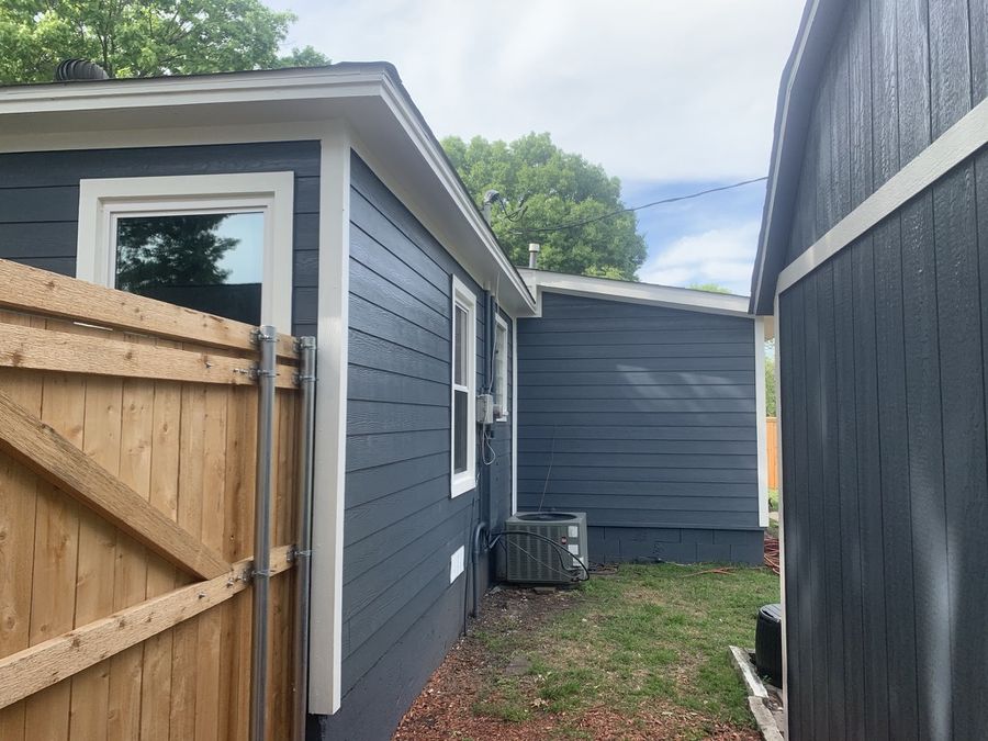 Whole-house re-side, cream to navy in Downtown Garland — After — side yard