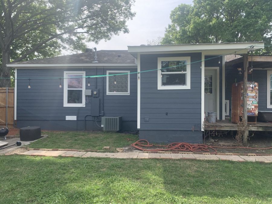 Whole-house re-side, cream to navy in Downtown Garland — After — rear