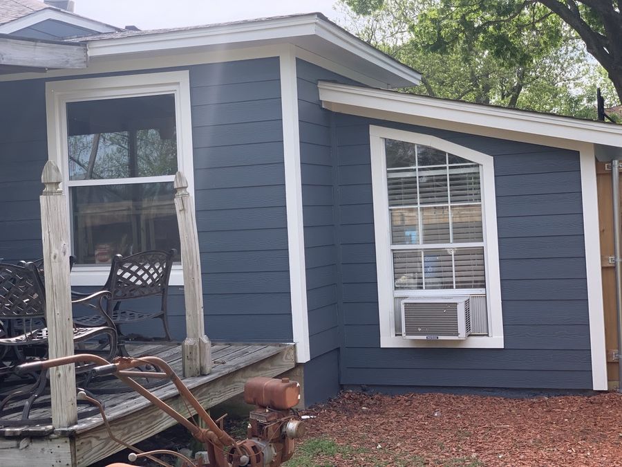 Whole-house re-side, cream to navy in Downtown Garland — After — side elevation