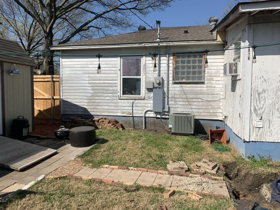 Whole-house re-side, cream to navy in Downtown Garland — Before — rear of the house