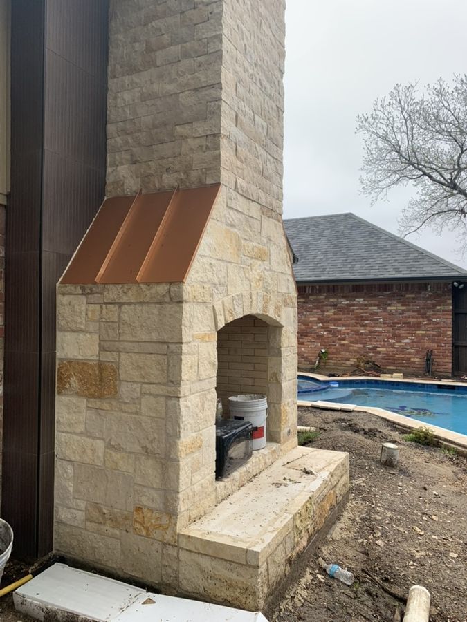 Copper flashing detail on a custom stone chimney