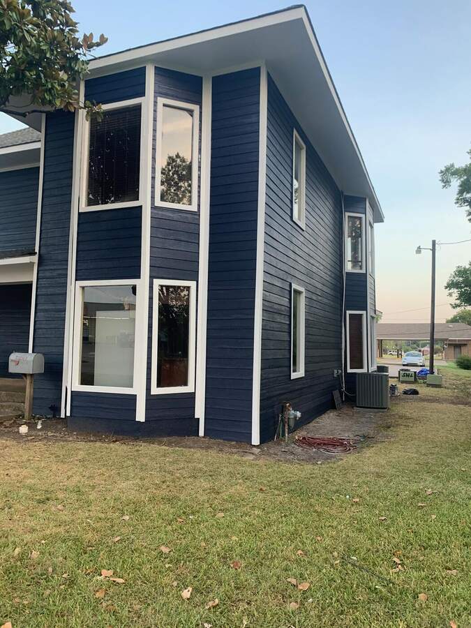 After: new navy siding, white trim and windows