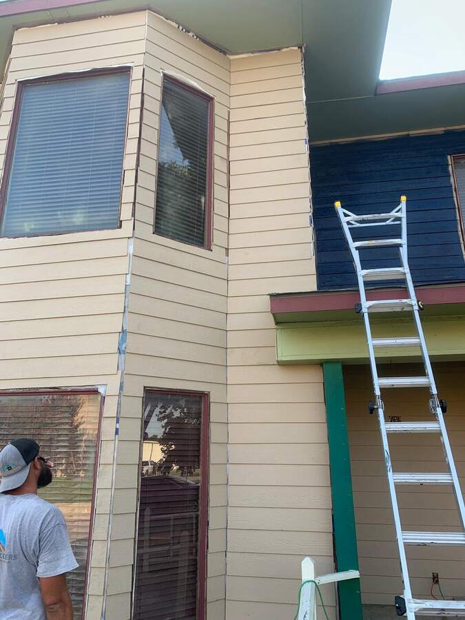 Before: faded two-tone siding with worn trim