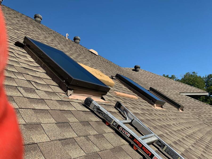 Two new skylights on a shingle roof