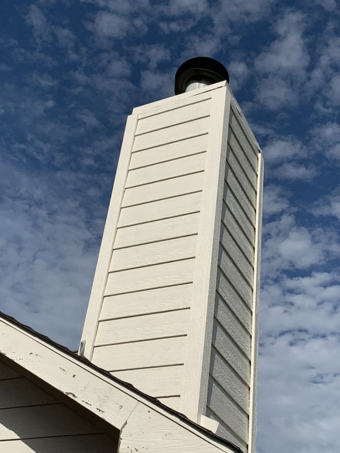 Two chimney chases stripped, re-sided and capped in Southlake — After — the second chase, cream