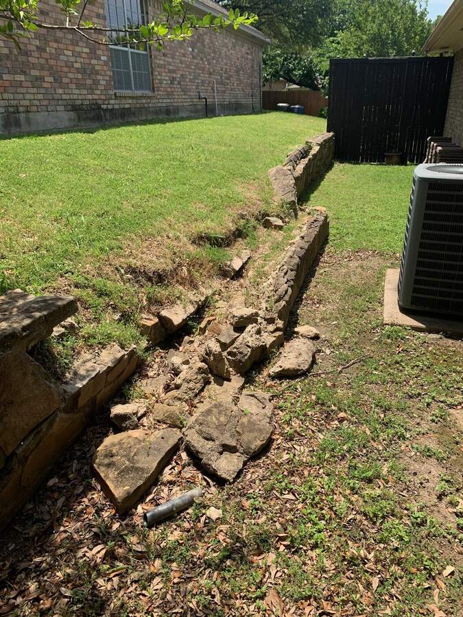 Old stone retaining wall removed down to the footing