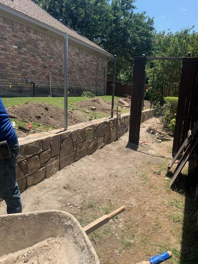 After: retaining wall rebuilt straight with steel posts
