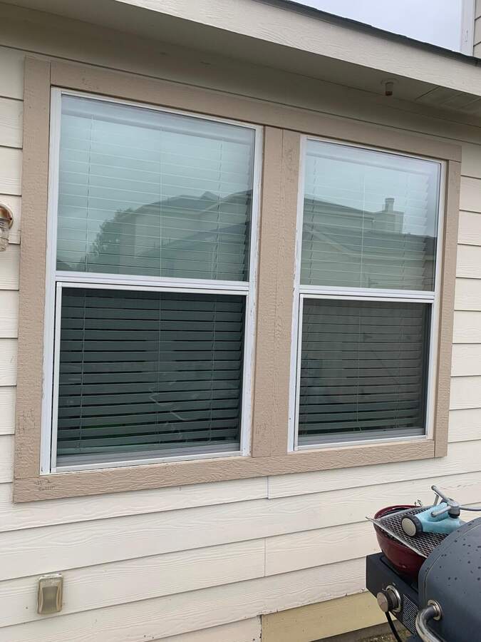 New double-hung windows in a siding wall